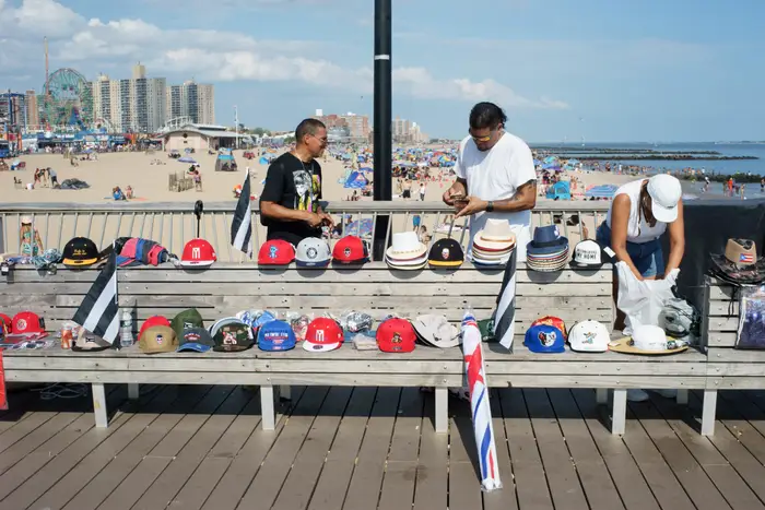 A photo of people selling hats at Steeplechase Pier